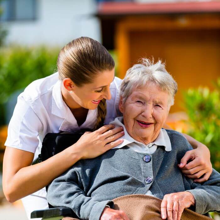Nurse with an elderly person of the community outdoors